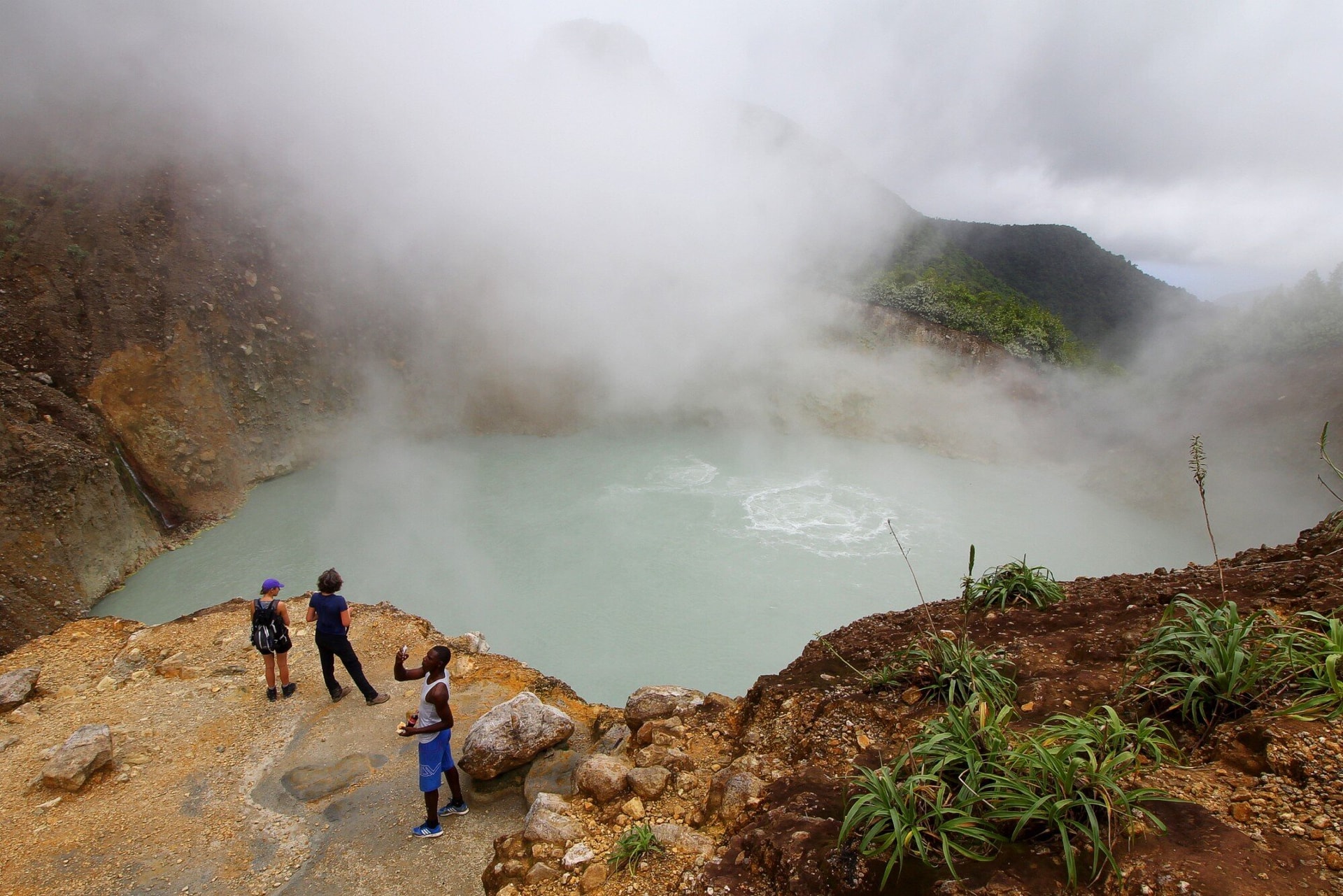 Hồ sôi (Dominica) có làn nước xanh xám sôi sùng sục. Vùng nước quanh rìa hồ có nhiệt độ cao từ 82 đến 92 độ C, đến nay nhiệt độ nước ở trung tâm hồ vẫn còn là bí ẩn. Phần xung quanh hồ dày đặc hơi nước, chứa thêm mùi lưu huỳnh cay nồng. Một số người đi bộ đường dài đã thiệt mạng ở đây do bị ngạt thở, bởi những vụ phun trào khí núi lửa đột ngột. (Ảnh: Davidmbyrne)