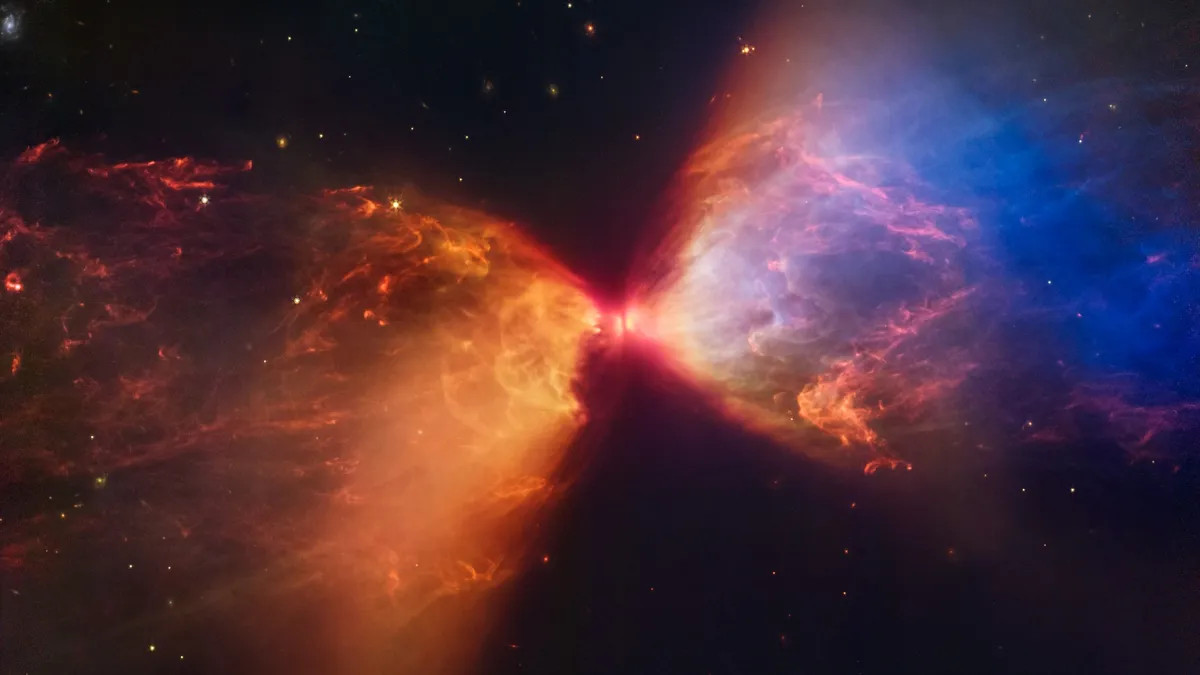 Một ngôi sao trẻ phun các dòng khí nóng phân tử vào đám mây bụi xung quanh, tạo ra một “chiếc đồng hồ cát rực lửa” trong chòm sao Taurus. (Ảnh: NASA)