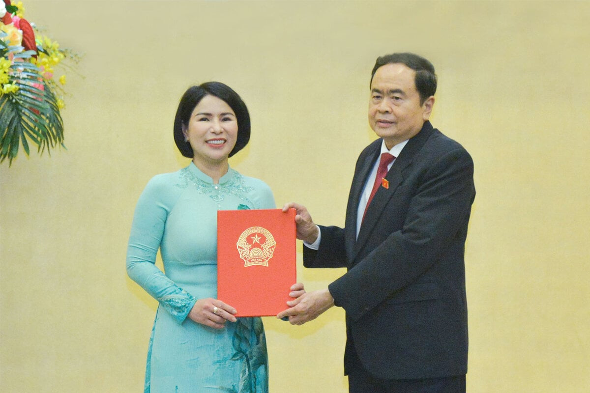 Phó Chủ tịch Thường trực Quốc hội Trần Thanh Mẫn trao nghị quyết cho Phó Trưởng Ban Dân nguyện Trần Thị Nhị Hà. (Ảnh: Hồ Long)