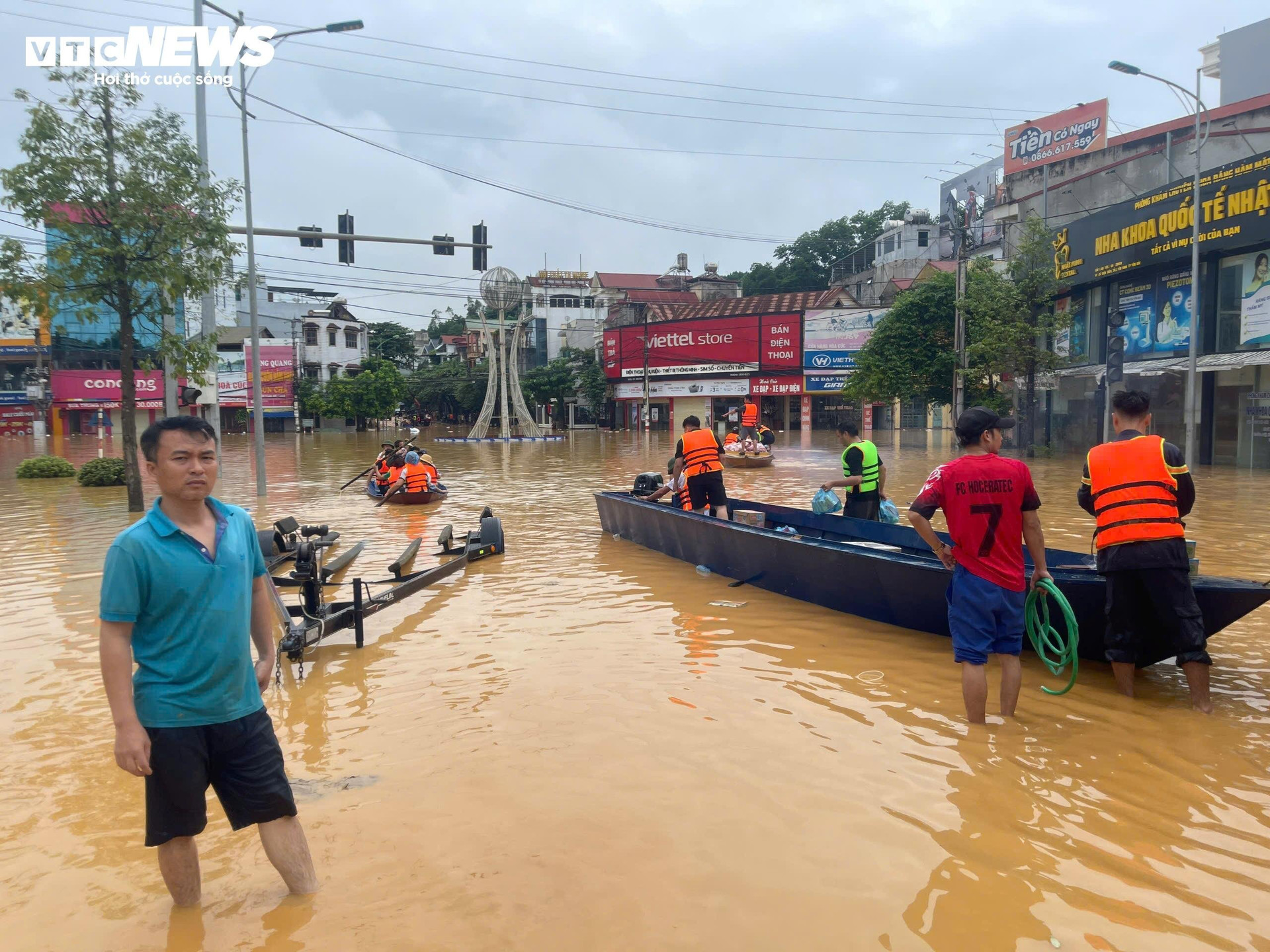 Các đoàn cứu trợ phải dùng thuyền máy và xe lội nước để vận chuyển hàng hóa đến người dân ở thành phố Yên Bái.