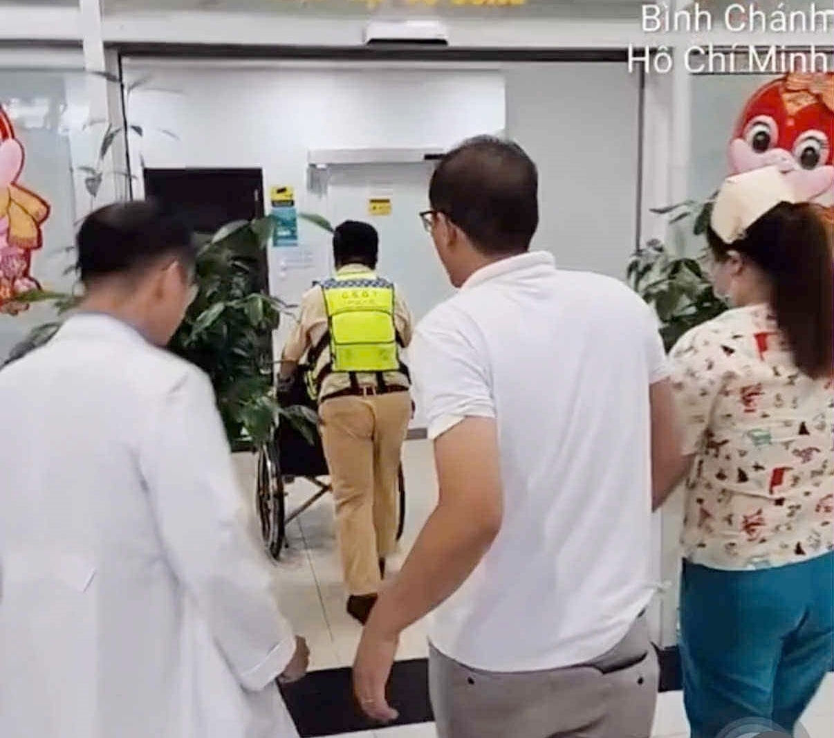 Các chiến sĩ CSGT cùng gia đình đưa thai phụ gặp nguy hiểm vào bệnh viện. (Ảnh: B.L)