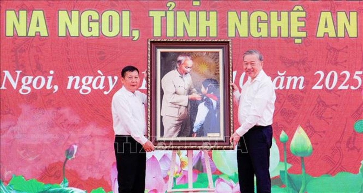 Tổng Bí thư Tô Lâm trao tặng nhà trường bức ảnh “Bác Hồ quàng khăn đỏ cho học sinh”. (Ảnh: Trịnh Duy Hưng/TTXVN)