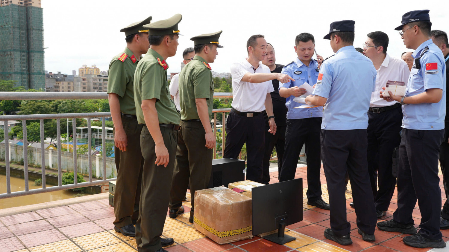 Lực lượng chức năng bàn giao tài liệu, tang vật có liên quan cho Công an Trung Quốc. (Ảnh: Trần Quang)